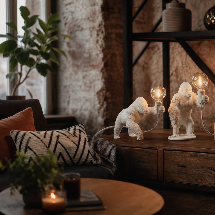 White gorilla table lamps with Edison bulbs on rustic wooden sideboard in industrial living room